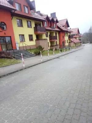 a cobblestone street in front of a row of houses at APARTAMENT LUCYNA in Rabka