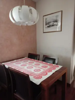 a dining room with a table and chairs and a chandelier at APARTAMENT LUCYNA in Rabka