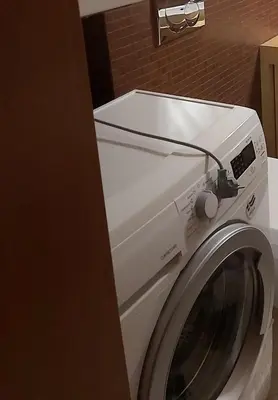 a white washing machine sitting in a bathroom at APARTAMENT LUCYNA in Rabka