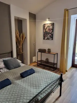 a bedroom with a bed and a table at Apartament pod Wawelem in Kraków
