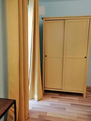 a room with a cabinet and a curtain at Apartament pod Wawelem in Kraków