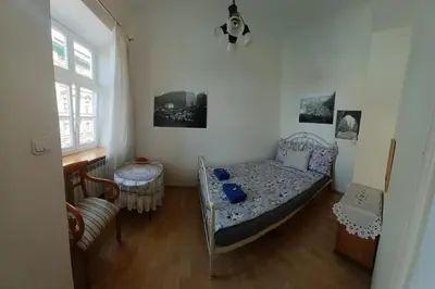 a small bedroom with a bed and a window at Paderewskiego Old Town Apartaments in Kraków