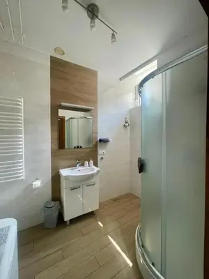 a bathroom with a sink and a shower at Paderewskiego Old Town Apartaments in Kraków