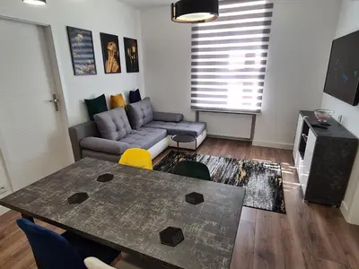 a living room with a table and a couch at Paderewskiego Old Town Apartaments in Kraków