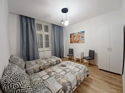 a living room with a couch and a table at Paderewskiego Old Town Apartaments in Kraków