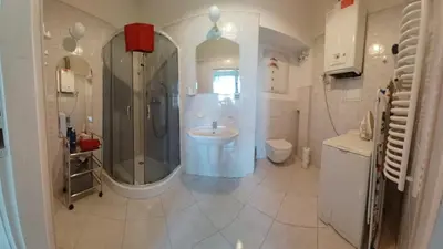a bathroom with a shower and a sink and a toilet at Paderewskiego Old Town Apartaments in Kraków