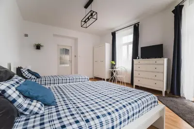 a bedroom with two beds and a dresser at Kawiory 2 in Kraków