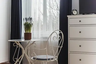 a chair and a table in front of a window at Kawiory 2 in Kraków