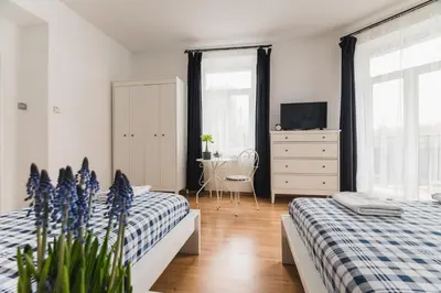 a bedroom with two beds and a dresser at Kawiory 2 in Kraków