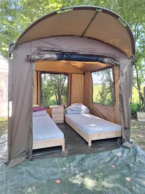 two beds in a tent in a yard at Pole Namiotowe Kogutowo in Wietrzychowice