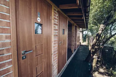 a wooden door on the side of a house at Pole Namiotowe Kogutowo in Wietrzychowice
