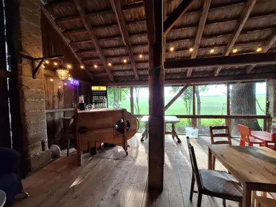 a room with a desk and tables in a building at Pole Namiotowe Kogutowo in Wietrzychowice