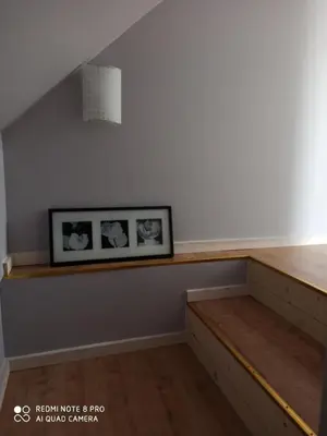 a room with a shelf with two pictures on the wall at Domek Całoroczny Pod Dworem in Wola Kalinowska