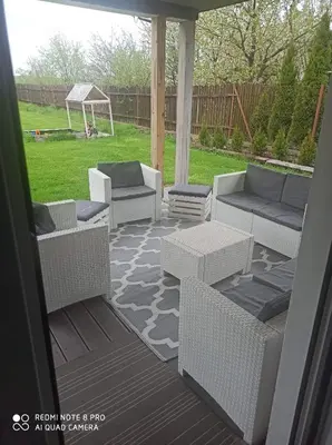 a patio with couches and a gazebo at Domek Całoroczny Pod Dworem in Wola Kalinowska