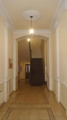 an empty hallway with a staircase in a building at Apartament z Antresolą Kraków Kazimierz Bożego Ciała in Kraków