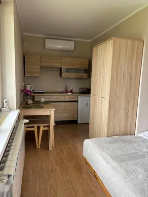 a kitchen with a table and a bed in a room at Azalia Zator in Zator