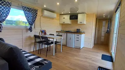 a small kitchen with a table in a tiny house at Azalia Zator in Zator