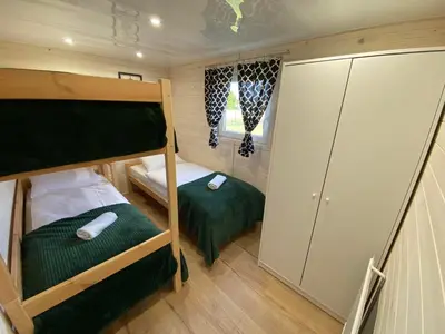 a small bedroom with two bunk beds and a closet at Azalia Zator in Zator