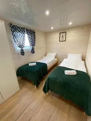 a room with two beds in a small room at Azalia Zator in Zator