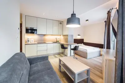 a living room with a couch and a table at Deluxe Apartment Rakowicka 15 WAWELOFTS in Kraków