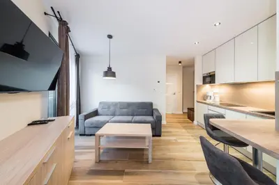 a living room with a couch and a table at Deluxe Apartment Rakowicka 15 WAWELOFTS in Kraków