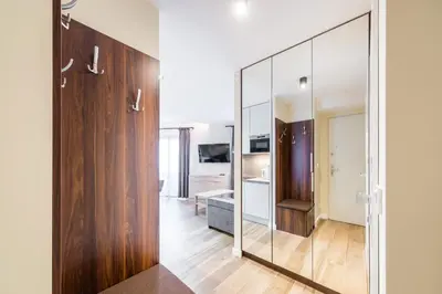 a large mirror in a room with a bathroom at Deluxe Apartment Rakowicka 15 WAWELOFTS in Kraków