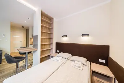 a bedroom with a bed and a desk in it at Deluxe Apartment Rakowicka 15 WAWELOFTS in Kraków