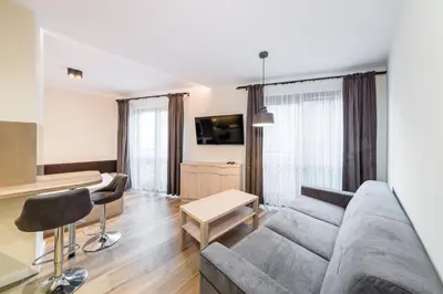 a living room with a couch and a table at Deluxe Apartment Rakowicka 15 WAWELOFTS in Kraków