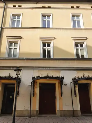 a large building with three doors and windows at Exclusive Loft in the Main Square A/C p4you pl in Kraków
