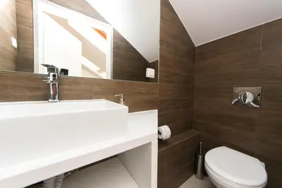 a bathroom with a sink and a toilet at Exclusive Loft in the Main Square A/C p4you pl in Kraków