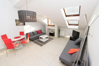 a living room with a couch and a table at Exclusive Loft in the Main Square A/C p4you pl in Kraków