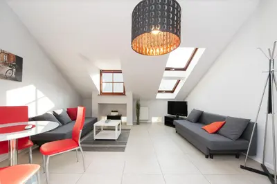a living room with a couch and a table at Exclusive Loft in the Main Square A/C p4you pl in Kraków