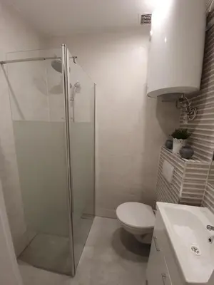 a bathroom with a shower and a toilet and a sink at apartament in Kraków