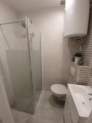 a bathroom with a shower and a toilet and a sink at apartament in Kraków