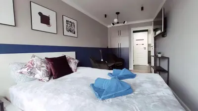 a bedroom with a white bed with blue towels on it at Kremerowska 9 by Homeprime in Kraków