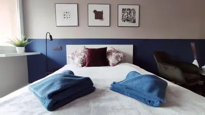 a bed with two blue towels on top of it at Kremerowska 9 by Homeprime in Kraków