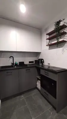 a kitchen with a sink and a stove top oven at Kremerowska 9 by Homeprime in Kraków