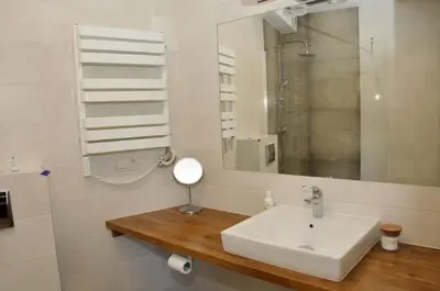 a bathroom with a sink and a mirror at Lipowe Wzgórze Limanowa in Limanowa