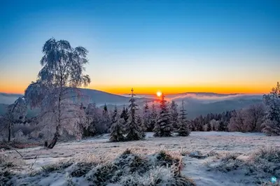 a winter sunset in the mountains with snow covered trees at Lipowe Wzgórze Limanowa in Limanowa