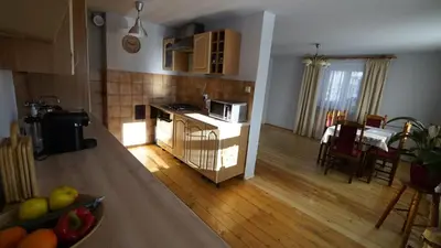 a kitchen and a living room with a table and a counter at Zawoja Dom Czatoża in Zawoja