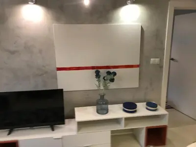 a living room with a tv and a table at Browar Lubicz 17b apartament 11 by Atrium Apartments in Kraków