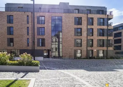 a brick building with a courtyard in front of it at Browar Lubicz 17b apartament 11 by Atrium Apartments in Kraków