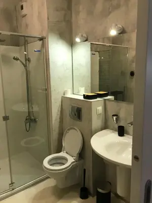a bathroom with a shower and a toilet and a sink at Browar Lubicz 17b apartament 11 by Atrium Apartments in Kraków