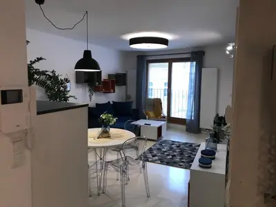 a kitchen and living room with a table and a kitchen and a living room at Browar Lubicz 17b apartament 11 by Atrium Apartments in Kraków