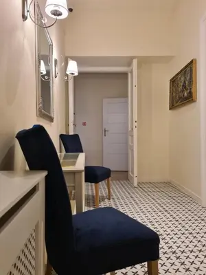 a living room with two chairs and a table at AMBER APARTAMENT 1112 in Kraków