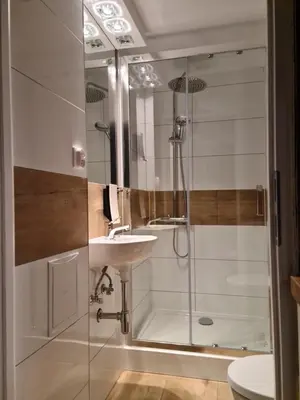 a bathroom with a shower and a sink at AMBER APARTAMENT 1112 in Kraków