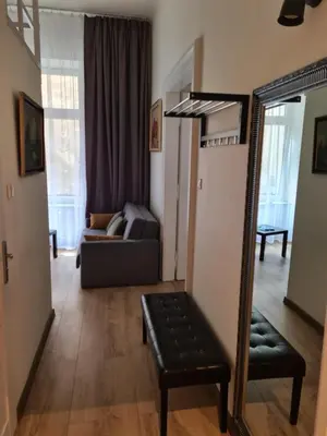 a living room with a mirror and a couch at AMBER APARTAMENT 1112 in Kraków