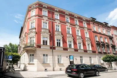 a large building with a car parked in front of it at Elegant Apartment Luminis in Krakow's Old City in Kraków
