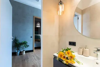 a bathroom with a sink and a mirror at Elegant Apartment Luminis in Krakow's Old City in Kraków