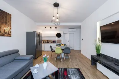 a living room with a couch and a table at Kazimierz Old Town Apartments in Kraków